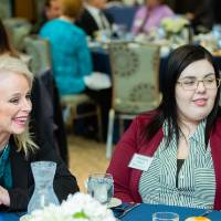 Donor with a student smiling together at a table at Scholarship Dinner 2019